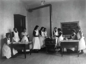 Breakfast lesson in home economics class for women. Carlisle Indian School, Pa. 1901. Creator: Frances Benjamin Johnston