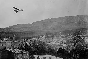 Morocco Prints: Breguet biplane, type 1910, flying over a town