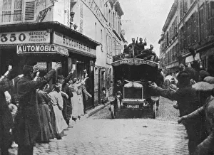 British troops receive a welcome as they arrive by motor van in a French town, 1915