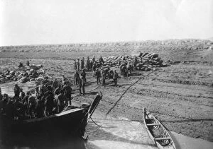 Two Decker Gallery: British troops unloading dates on the shore of the Tigris river, 1918