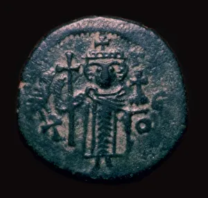Damascus Prints: Bronze fals showing a figure holding a cross, 7th century