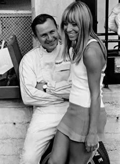 Bruce McLaren with female admirer in the pits, 1967 Italian Grand Prix. Creator: Unknown