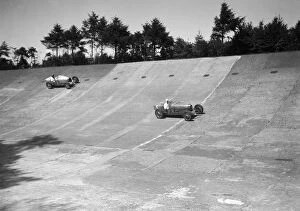 Race Collection: Two Bugatti Type 35s racing on the Members Banking at Brooklands. Artist: Bill Brunell