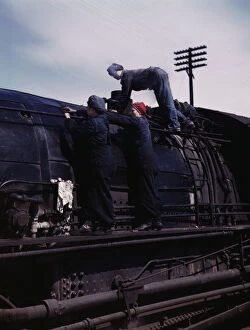 Chicago And North Western Railway Company Gallery: C. & N.W. R.R. women wipers at the roundhouse cleaning one of the giant... Clinton, Iowa, 1943