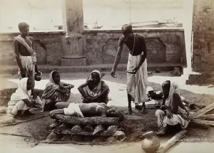 Funeral Prints: Calcutta, West Bengal: a man about to scatter material from a bowl on a dead body