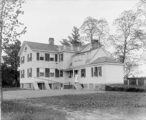 Calloway residence, back, showing porch with woman, Mamaroneck, N.Y. between 1900 and 1915. Creator: William H. Jackson