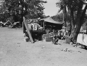 Camp of family with nine children... on the road for three years, Washington, Yakima Valley, 1939. Creator: Dorothea Lange