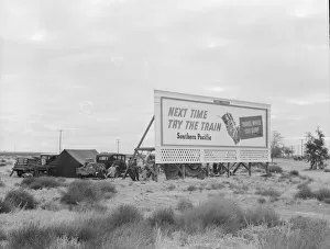 Camping Out Prints: Camped in the rain behind billboard