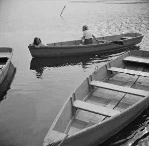 Teenager Collection: A camper returning a boat to the dock at Camp Gaylord White, Arden, New York, 1943