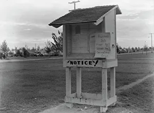Board Prints: Campers bulletin board near entrance of Shafter camp for migrant workers