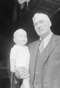 Captain Everett Edwards and baby, portrait photograph, 1933. Creator: Arnold Genthe