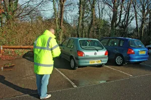 Number Prints: Car Park attendant recording car registration numbers