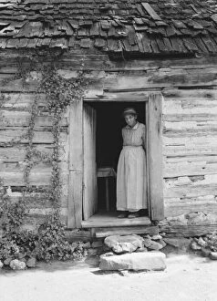 Elderly Gallery: Caroline Atwater standing in the kitchen doorway of...log house, North Carolina, 1939