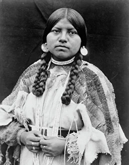Earring Collection: Cayuse woman, half-length portrait, standing, facing front, braids, shell disk earrings..., c1910