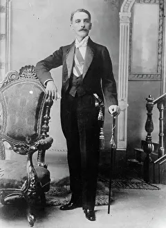 Colombian Prints: C.E. Restrepo posing next to chair, with cane, 1910. Creator: Bain News Service