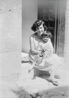 Group Portraits Prints: Cenerini, Mrs. and child, seated on a doorstep, 1929 Creator: Arnold Genthe