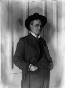 Champ Clark, half-length portrait, standing, facing right, hands in pants pockets, (1898?). Creator: Frances Benjamin Johnston