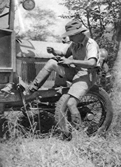 Chaplin Court Treatt, British motoring pioneer, mending his veldtschoen (shoes), c1924-c1926 (1927). Artist: Thomas A Glover