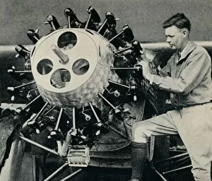 Charles Lindbergh checking the engine of his aircraft before his transatlantic flight, 1927 (c1937)