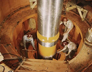 Construction Worker Gallery: Checking the alignment of a turbine shaft at the top of the guide... Watts Bar Dam, Tenn. 1942