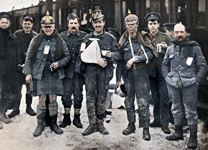 Cheerful Gallery: Some cheerful wounded from the Neuve Chapelle fighting, wearing captured German helmets, 1915