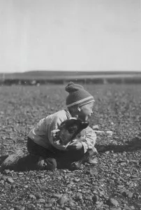 Woolly Hat Prints: Child and calf, between c1900 and c1930. Creator: Unknown