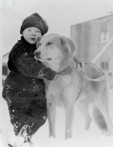 Sled Dog Prints: Child with dog, between c1900 and c1930. Creator: Unknown