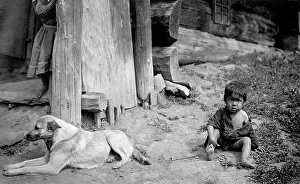 Russian Federation Prints: A Child with a Dog by a Yurt, 1913. Creator: GI Ivanov