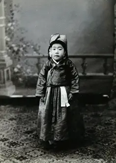 Childrenswear Prints: A child posing in front of a painted backdrop in a photographic studio