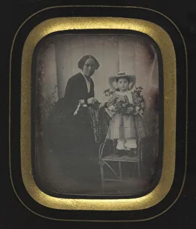 Unidentified Photographer Prints: Child Standing on a Chair Holding Flowers, with Mother, c