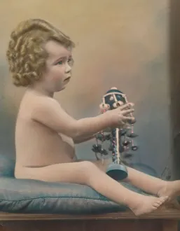Curly Prints: Child with toy, c1920