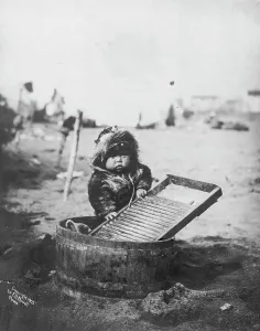 Washboard Prints: Child at washtub, c1905. Creator: Frank H. Nowell