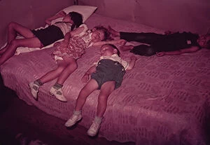 Sleep Gallery: Children asleep on bed during square dance, McIntosh County, Okla. 1939 or 1940