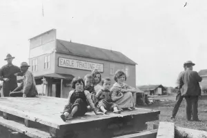 Settlers Prints: Children outside Eagle Trading Company, between c1900 and 1916. Creator: Unknown