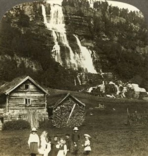 Underwood Travel Library Gallery: Children at play in a farmers field with terraced Tvinde waterfall, Vossevangen