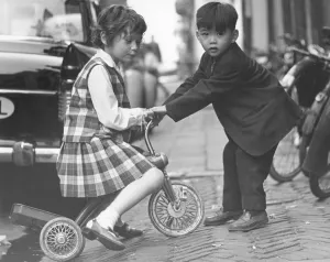 Tricycle Prints: Children playing with a tricycle, c1960s