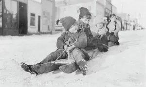 Settlers Prints: Children sleigh riding, between c1900 and c1930. Creator: Unknown