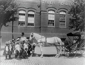 Buggy Prints: Children studying a horse and buggy outside the Tyler School
