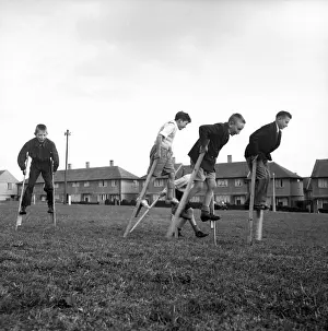 Stilts Prints: Children walking on stilts, c1955. Creator: Arthur Charles Kirby Ware