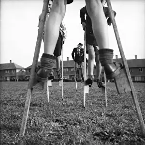 Stilts Prints: Children walking on stilts, c1955. Creator: Arthur Charles Kirby Ware