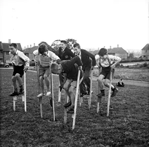 Stilts Prints: Children walking on stilts, c1955. Creator: Arthur Charles Kirby Ware