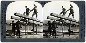 Chinese men sawing timber for the Japanese army, Manchuria, Russo-Japanese war, 1904-1905.Artist: Keystone