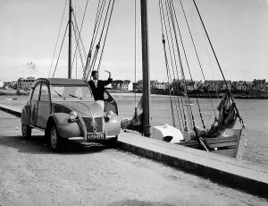 Harbour Front Prints: A Citroen 2CV on the quay at a harbour, c1957