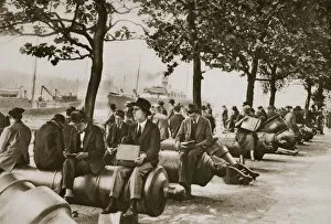 Lunchbreak Collection: City workers lunching at Tower wharf, seated on old cannons, c1920s-c1930s. Artist
