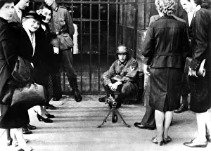 Occupied Prints: Civilians in front of a German guard post with a machine gun, Paris, June 1940