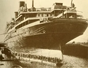 White Star Line Gallery: Cleaning the Hull of the Majestic in Dry Dock, c1930. Creator: Unknown