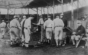 Baseball Cap Prints: Cleveland [AL] ball players selecting new bats; Graney on bench