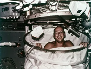 Floating Prints: Conrad in shower facility aboard Skylab 2, 1973. Creator: NASA