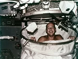 Conrad in shower facility aboard Skylab 2, 1973. Creator: NASA
