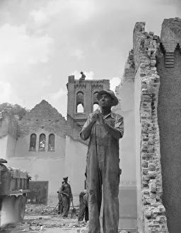 Pickaxe Prints: Construction workman wrecking a church on Independence Avenue